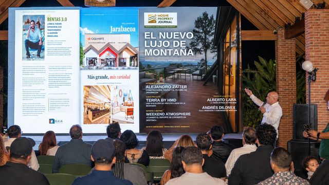 Asistentes miran en pantalla las páginas de la tercera edición de Moshe Property Journal en Jarabacoa