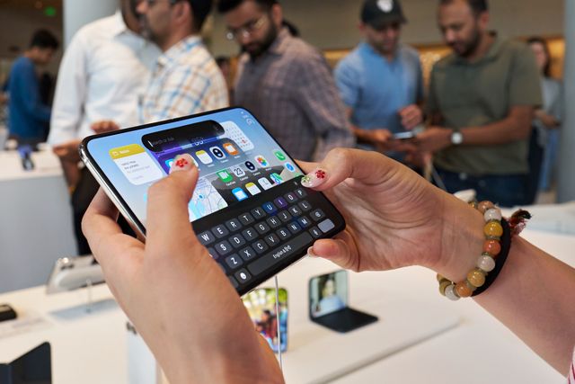 Una clienta escribe en la pantalla interior abierta de un iPhone Duo en una tienda Apple de Bombay