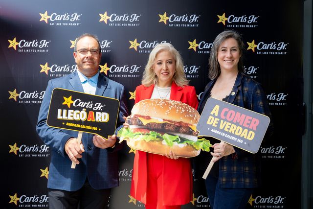 Julio Sánchez Capó, Mónica Cabrera Pérez y Maureen Brown con letreros de Carl's Jr.