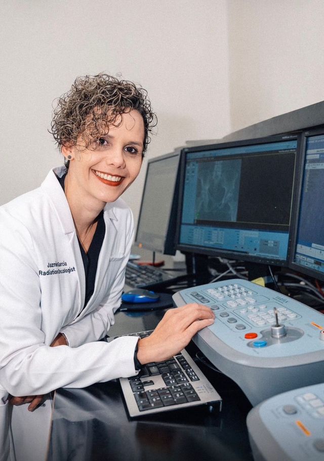 La oncóloga radioterápica Jazmín García frente a los monitores de un equipo de radioterapia
