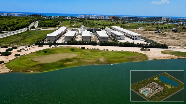 Vista aérea del proyecto residencial Marelago junto a un lago y un campo de golf en Cap Cana